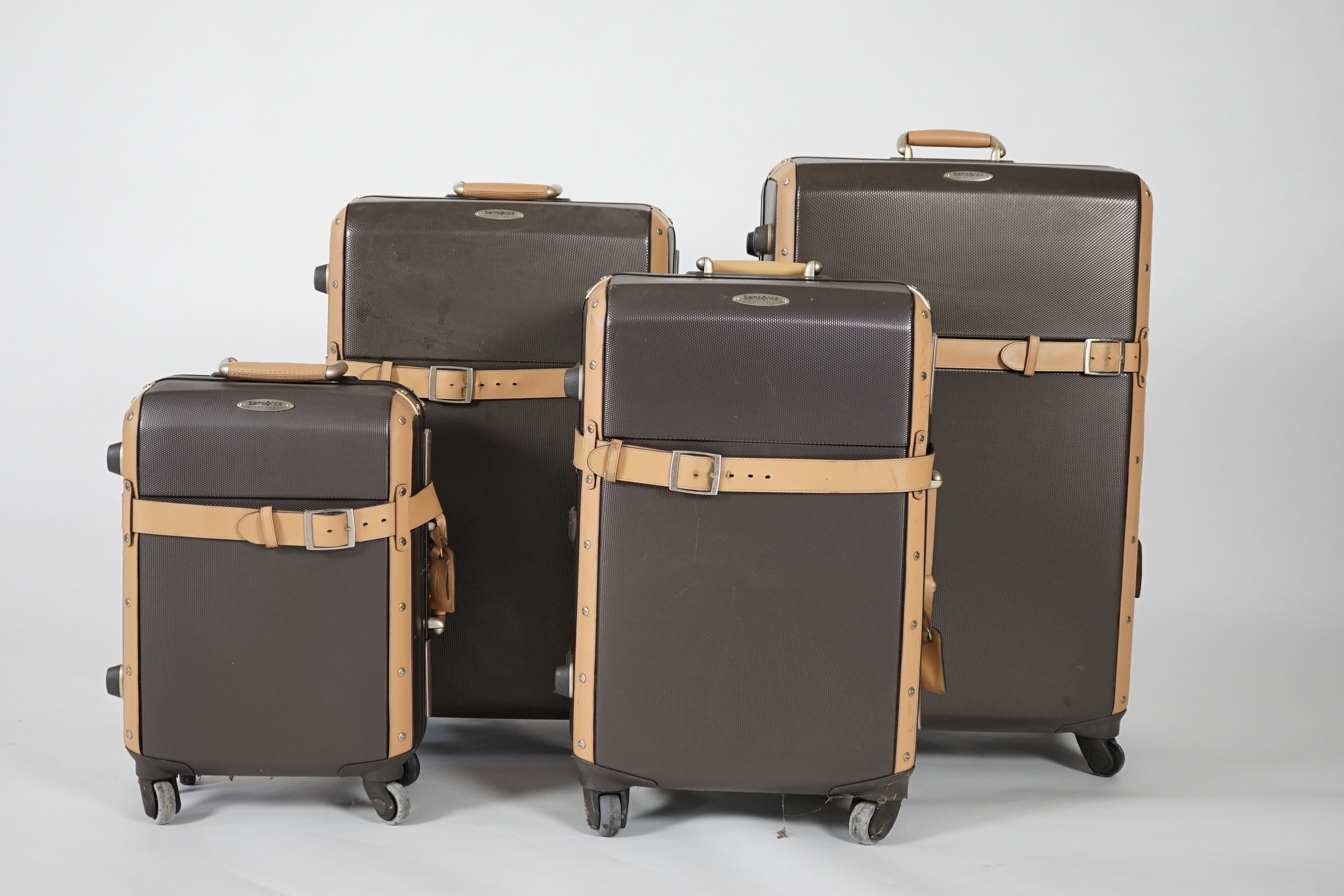 A graduated set of four Samsonite Black Label brown and tan hard suitcases, 83cm x 52cm x 34cm, 77cm x 48cm x 30cm, 66cm x 43cm x 27cm, 53cm x 36cm x 22cm